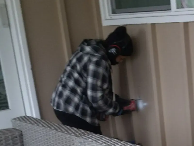 Professional electrician installing an exterior outlet in Eugene